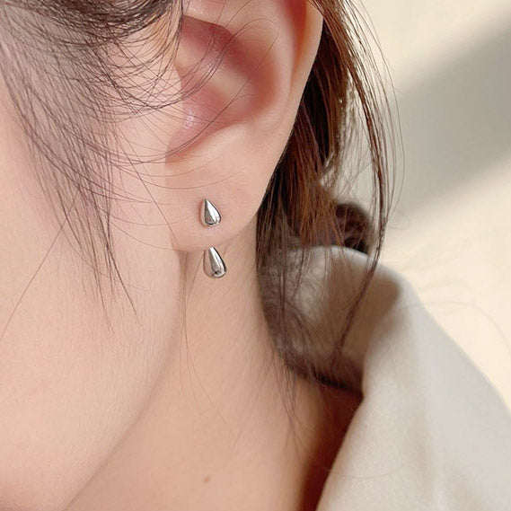 Model showcasing the elegant silver two-wear drop shape earrings