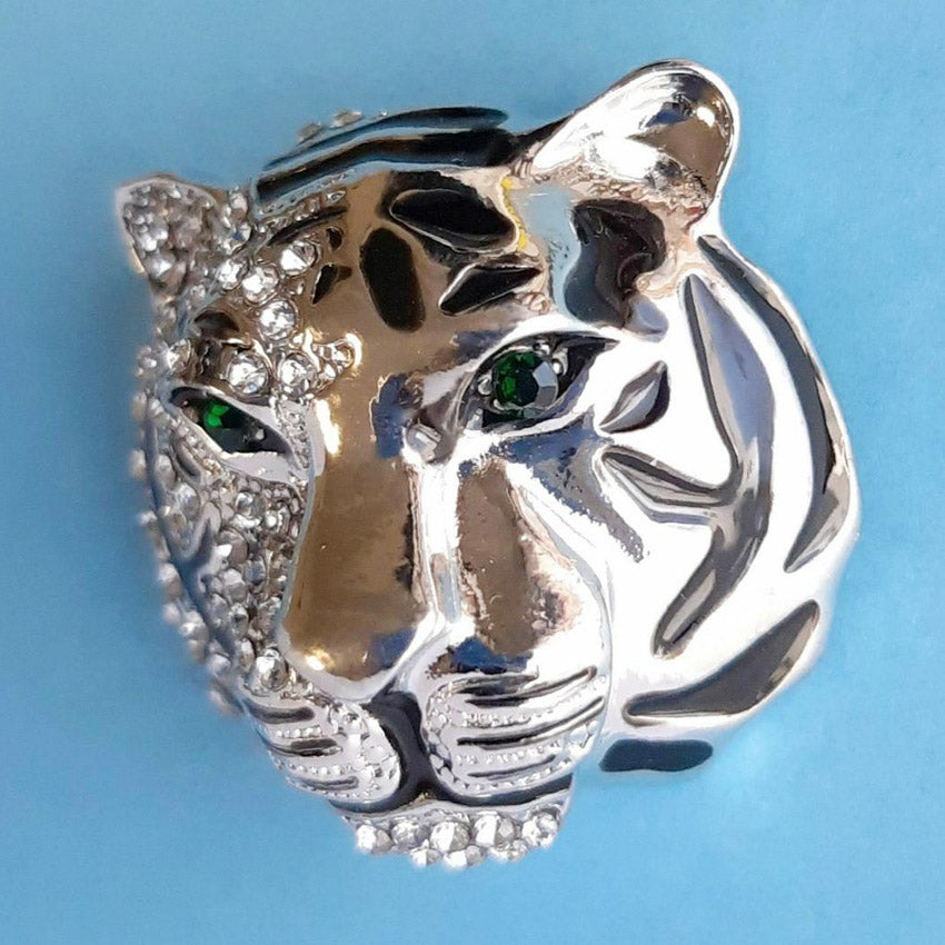 Detailed craftsmanship of the silver tiger head brooch with green eyes
