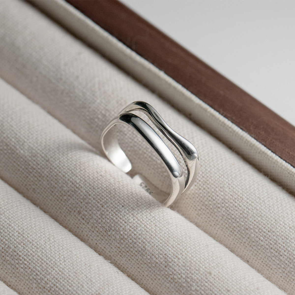 A clear product shot of the adjustable 925 sterling silver wave ring