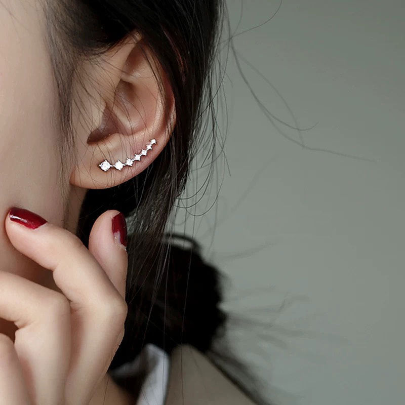 Model showcasing the elegant fit of the seven zircon climber stud earring.