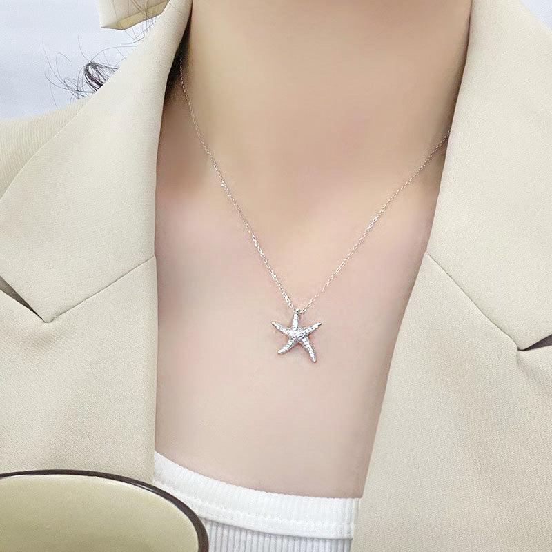 A sterling silver starfish necklace with a delicate chain and sparkling CZ stones.