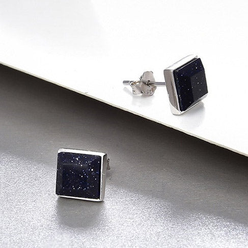 A detailed close-up of the starry night purple sandstone stud earring's surface.