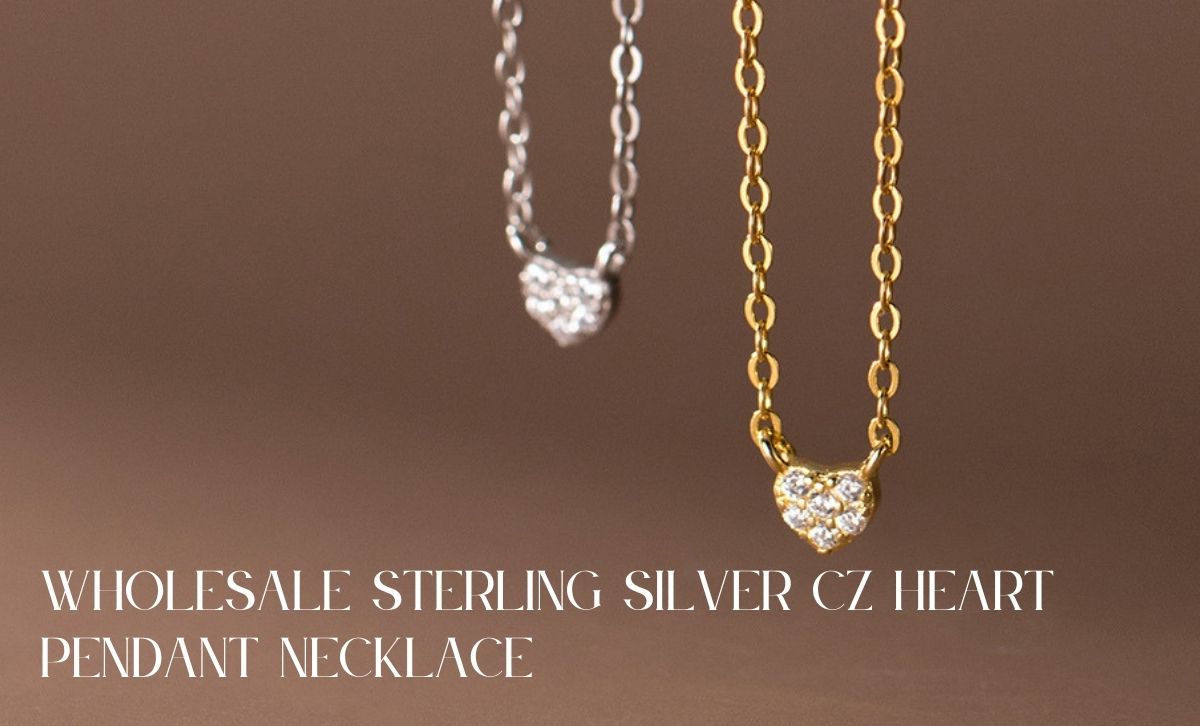 Wholesale sterling silver CZ heart pendant necklaces in both gold and silver finishes laid out for display.