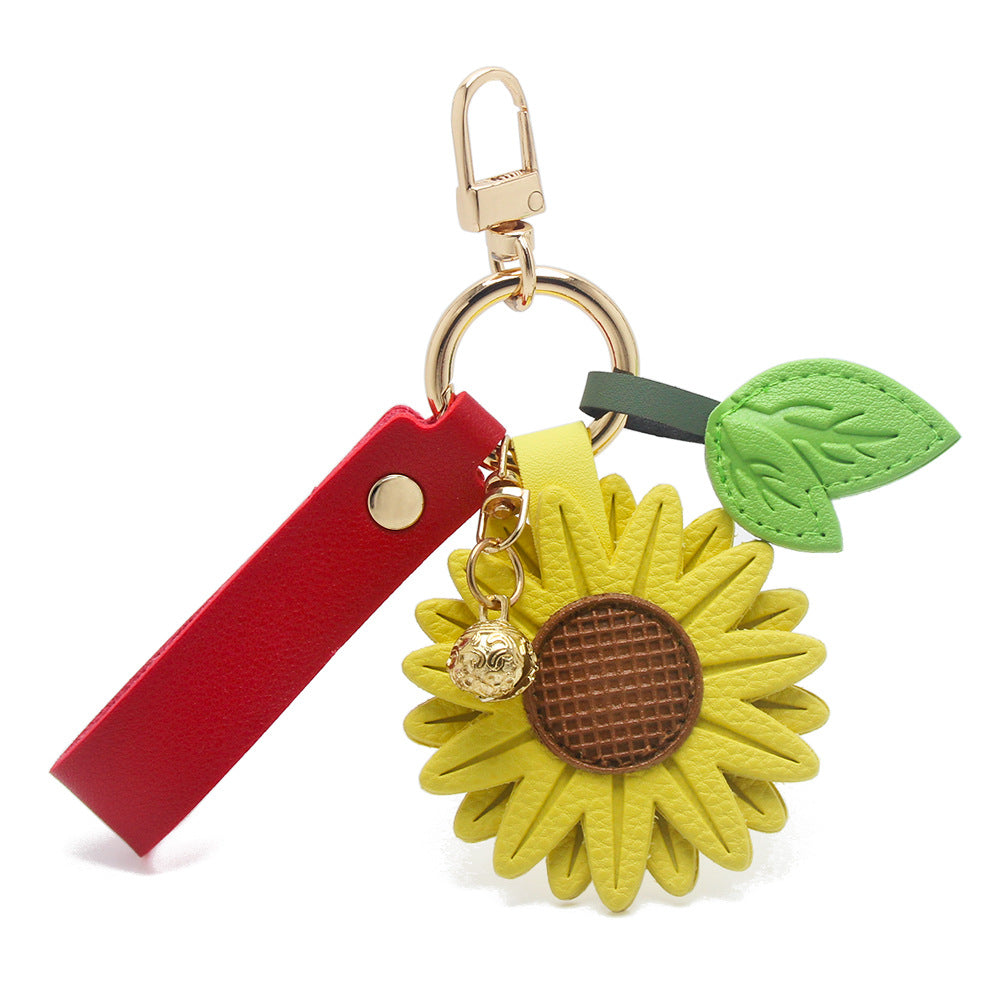 A red strap variant of the PU leather sunflower keychain, highlighting its durable construction and gold hardware.