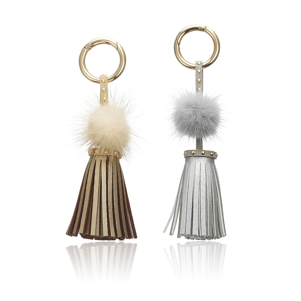Close-up of the leather and faux fur tassel keychain with gold hardware