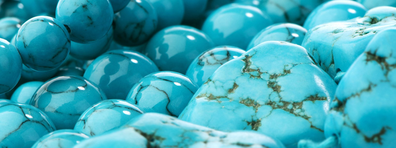 A collection of vibrant blue and green turquoise stones, the December birthstone.