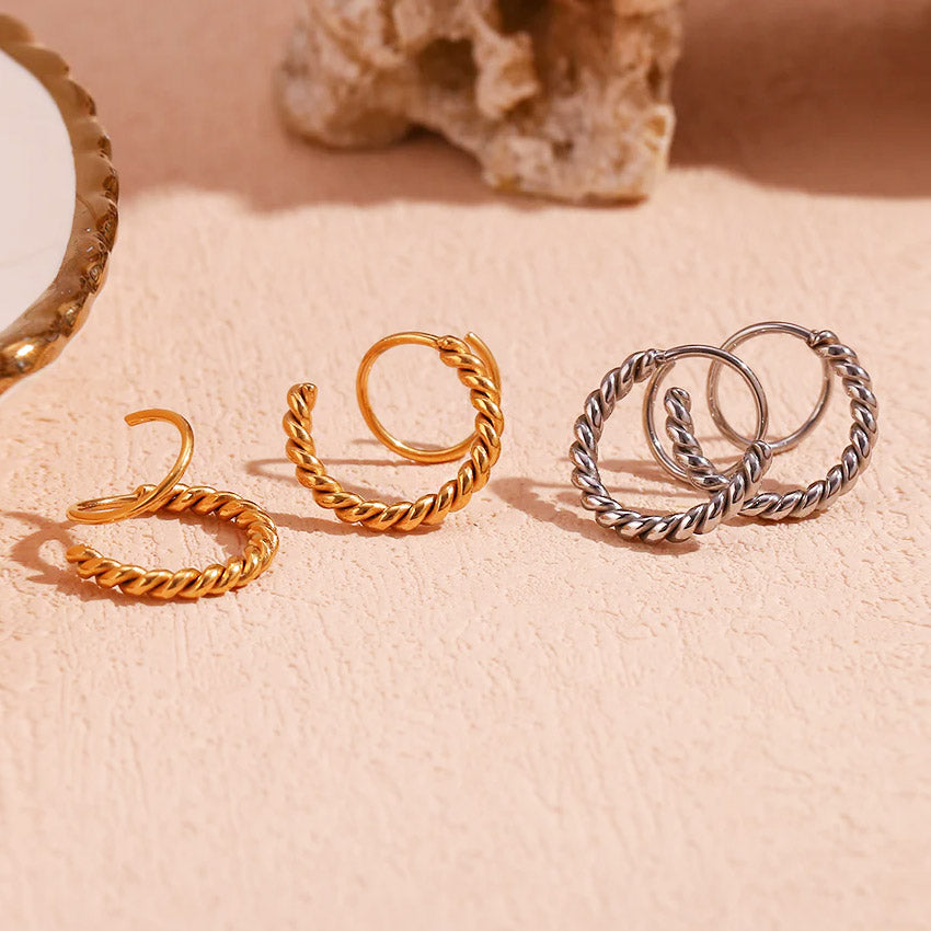 Four pairs of spiral twist earrings in gold and silver