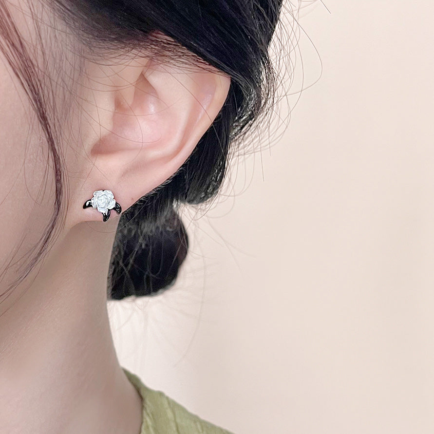 Model wearing the white flower stud earring