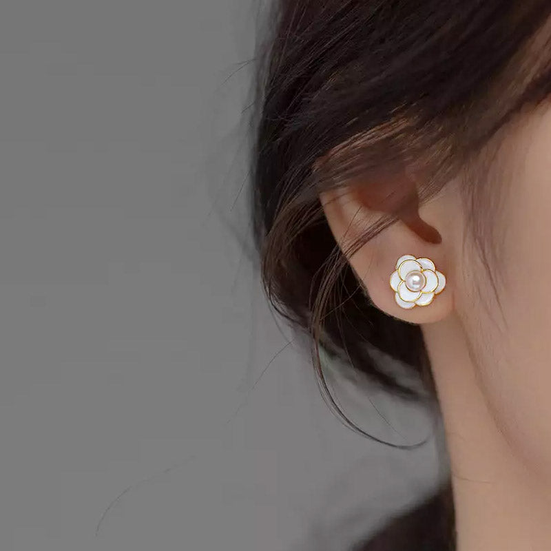 A model wearing the white enamel Camellia flower stud earring.
