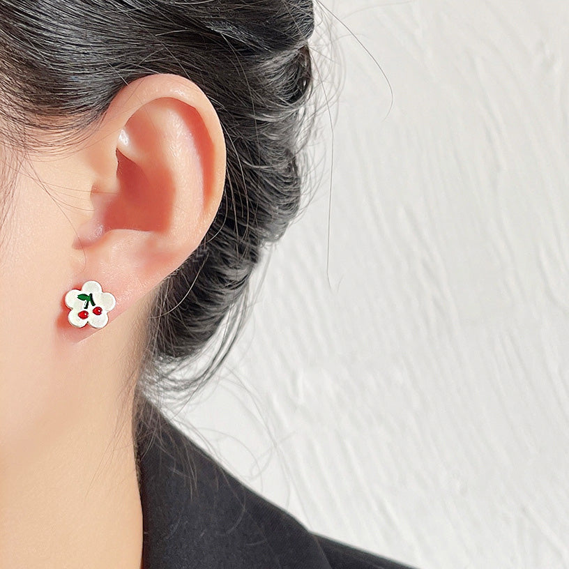 Model showcasing the cute flower and cherry enamel stud earring