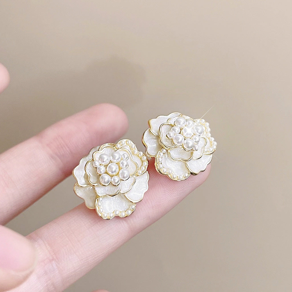 White enamel camellia flower earrings with gold trim and pearl centers