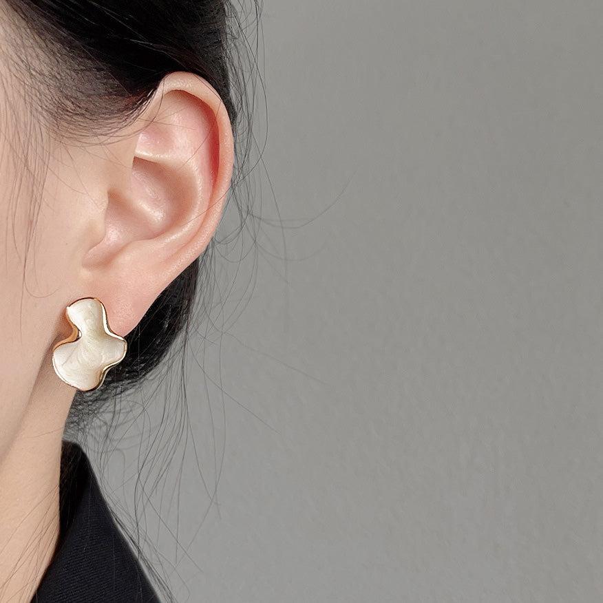Model wearing the 14k gold plated white enamel earring