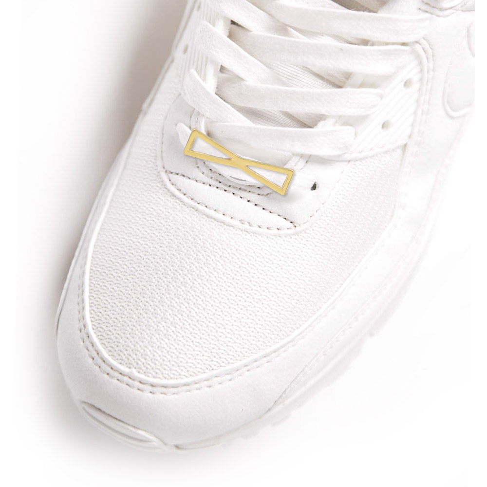 The Bow Shoe Charm shown on a white sneaker