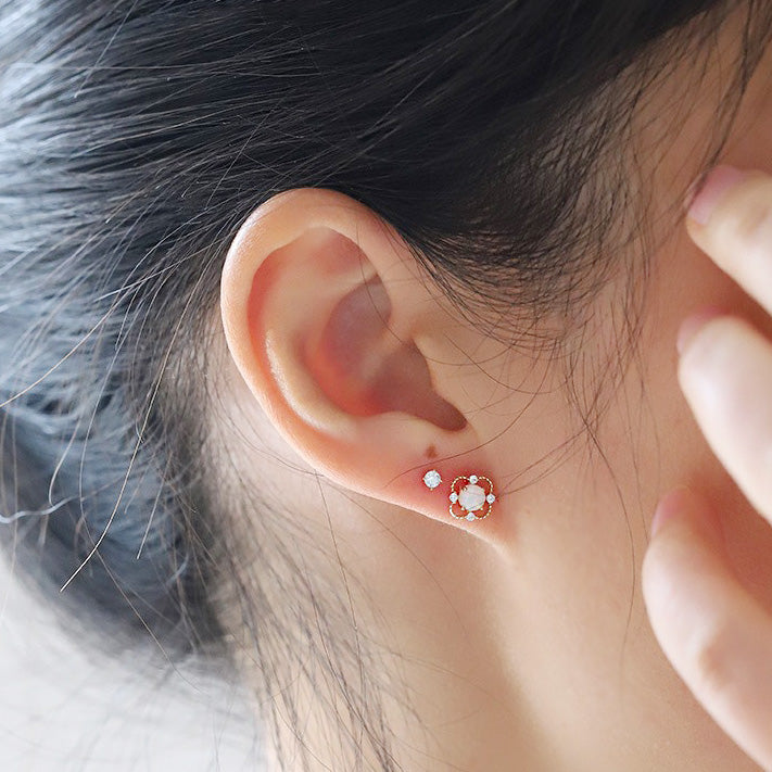 A model wearing the minimalist 925 sterling silver opal stud earring to showcase its size and appearance.