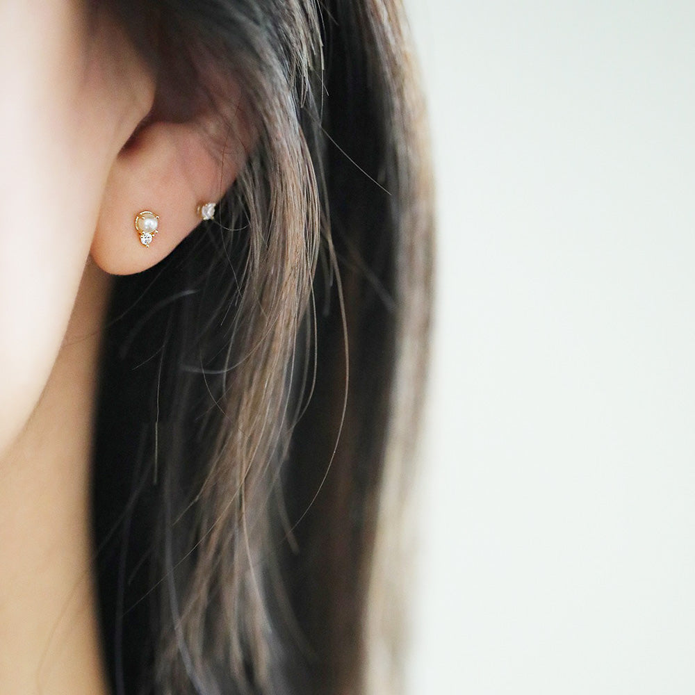 Model showcasing the versatile 925 sterling silver mini stud earring set.