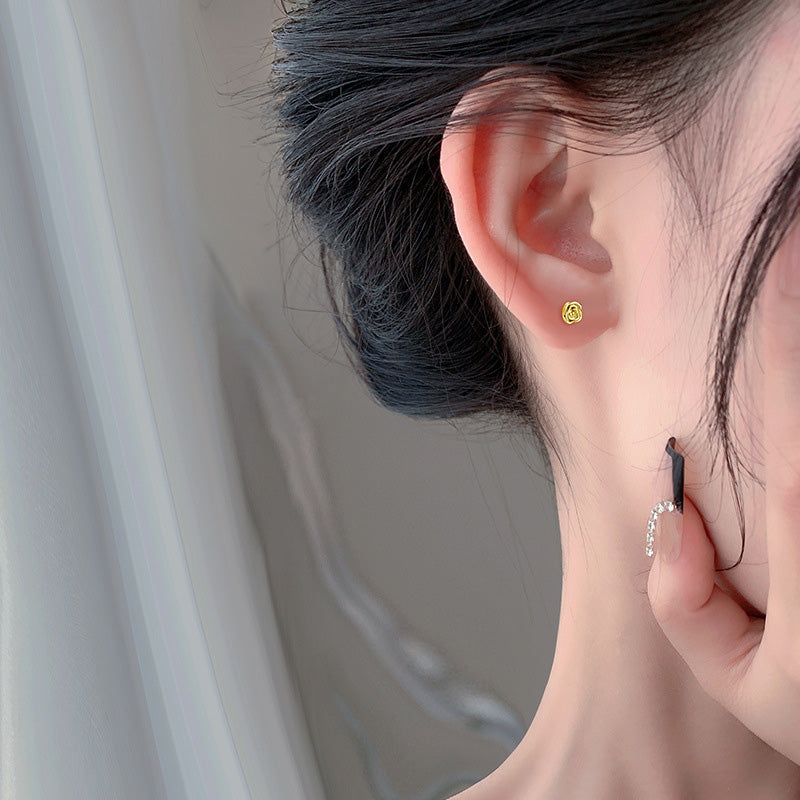 Model wearing the 925 sterling silver tiny flower rose stud earrings