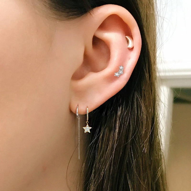 A model wearing the celestial star hoop earrings to show scale and style.
