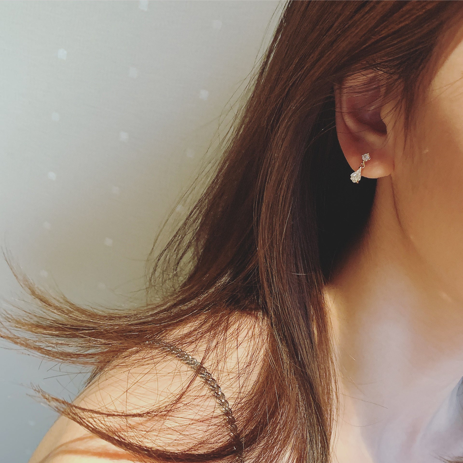 Model showcasing the sterling silver water drop crystal earrings