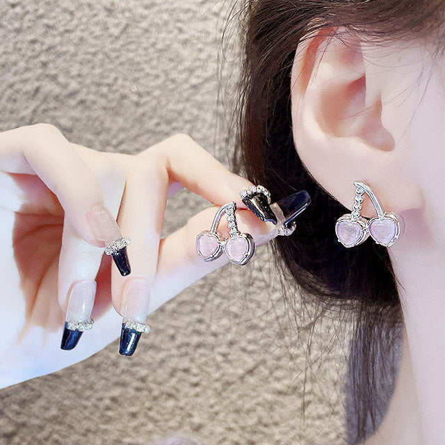 A model showcasing the elegant fit of the cherry stud earrings.
