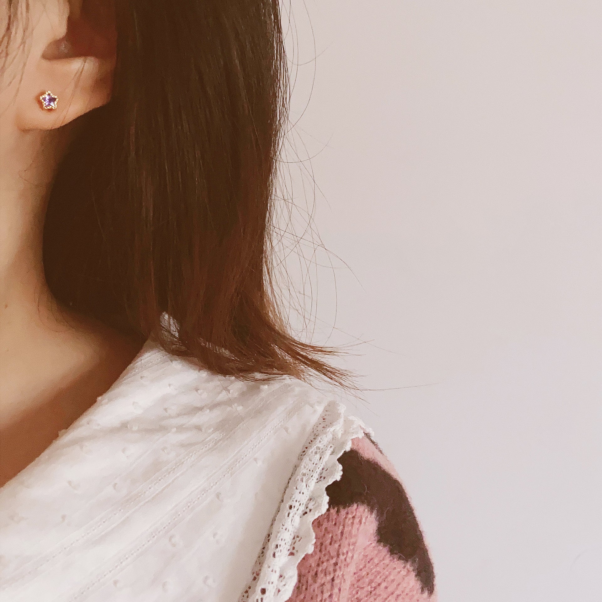 Model wearing the gold five-pointed star stud earrings, showcasing their elegant look.