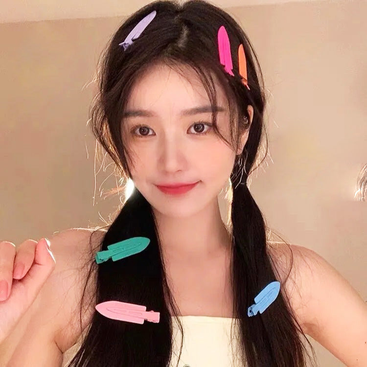 A model wearing the colorful no-crease hair clips to style her hair.