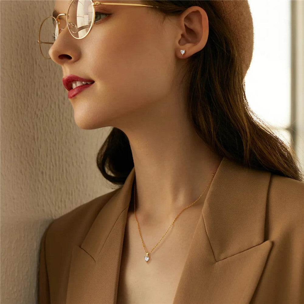 Model showcasing the elegant gold heart-shaped zircon necklace and earrings set.