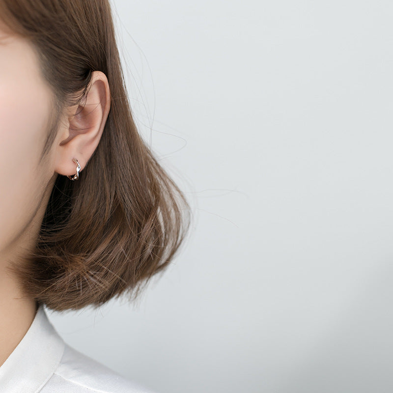 Model wearing the 12mm sterling silver twist hoop earrings