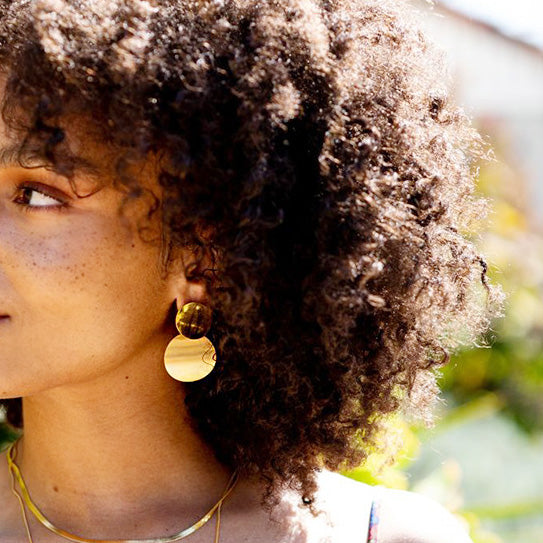 Model showcasing the modern stainless steel geometric drop earrings