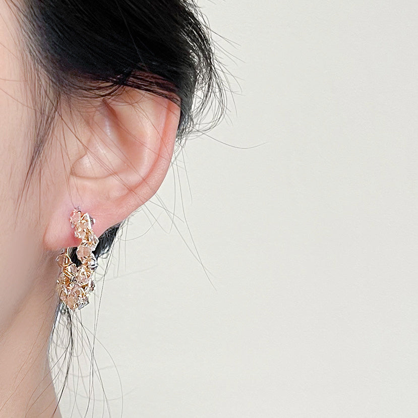Model showcasing the gold-plated crystal zircon hoop earrings, highlighting their elegant appeal.