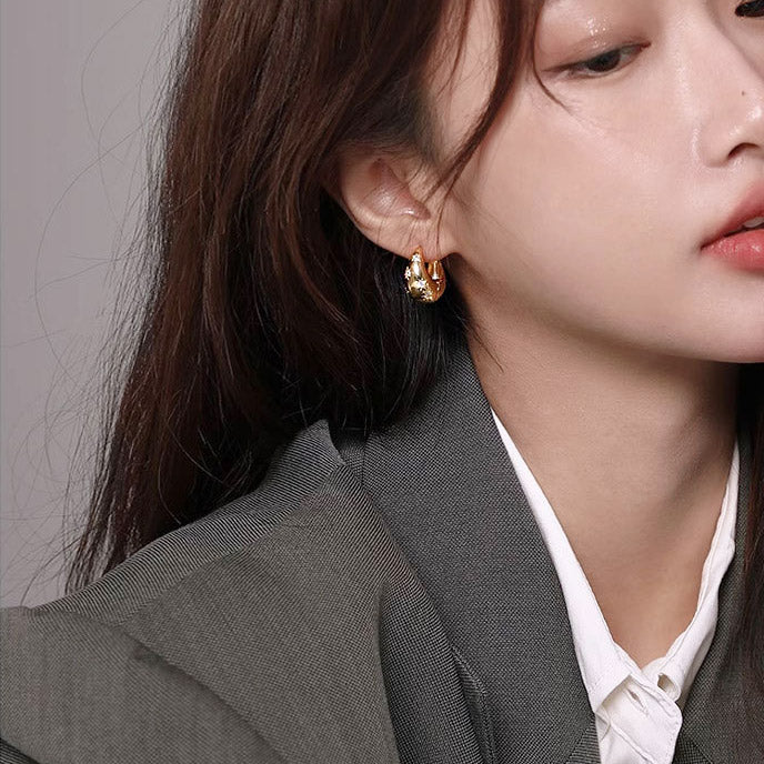 Model wearing the gold zircon star chunky hoop earrings