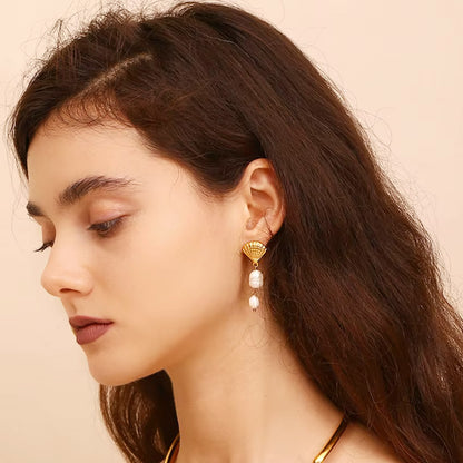 Model wearing the Gold Stainless Steel Shell Tassel Baroque Pearl Drop Earrings