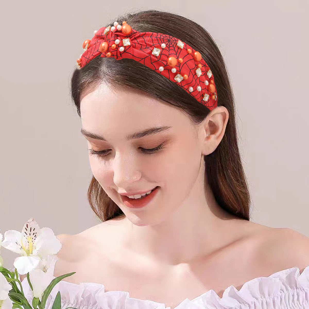 A woman models a stylish red beaded Halloween headband, showcasing its comfortable and fashionable look.