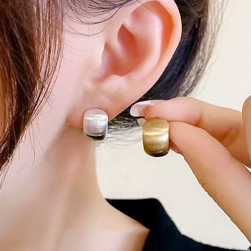 A woman models the versatile French metal bead stud earrings, showing both gold and silver options.