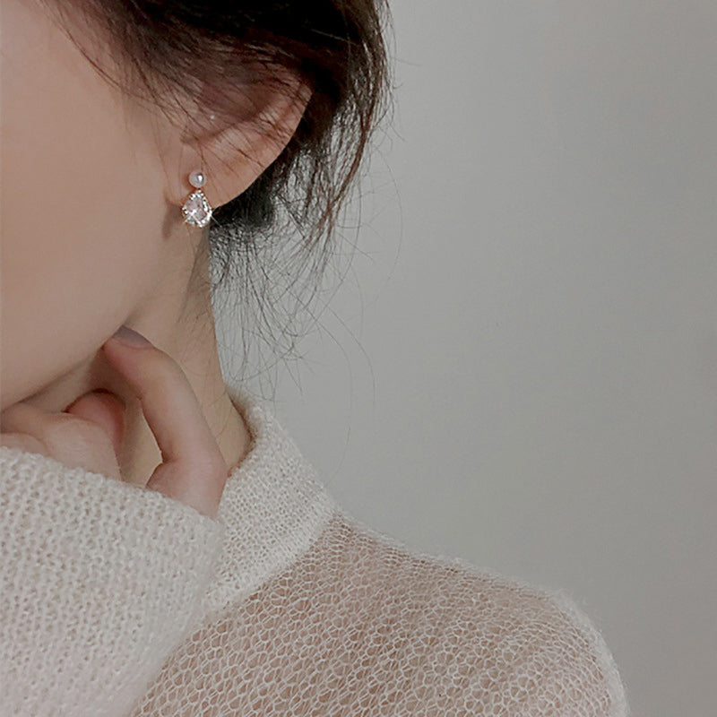 Model wearing the 925 silver pearl and zircon water drop earrings