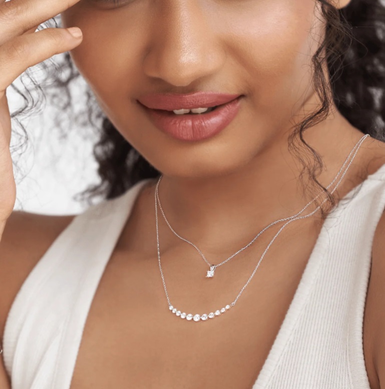 A woman wearing the stylish 925 Sterling Silver CZ Curved Bar Necklace