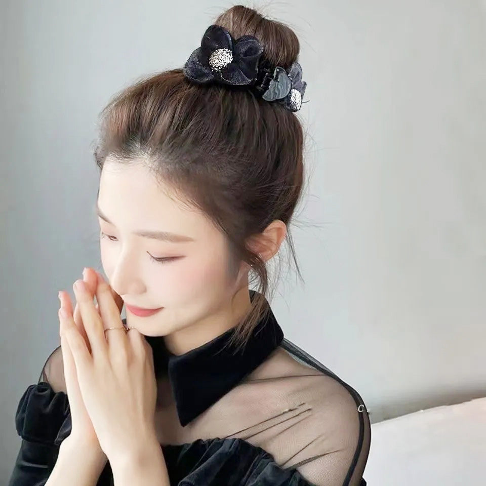 A woman elegantly wearing the black lace flower hair clip