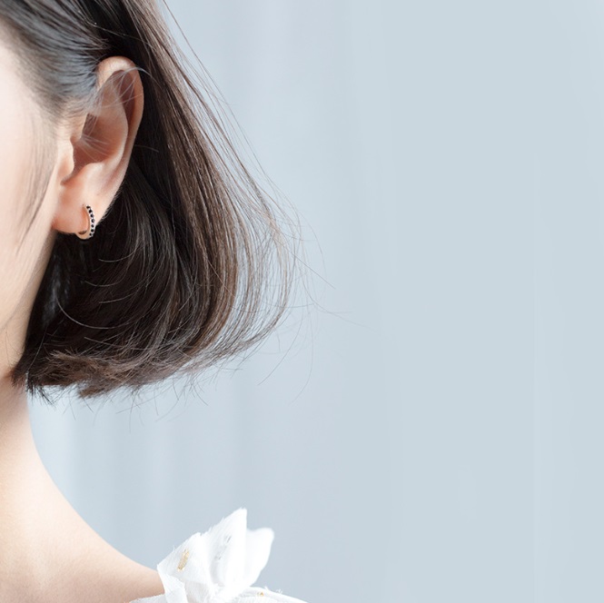 A model wearing the sterling silver hoop earrings with zirconia
