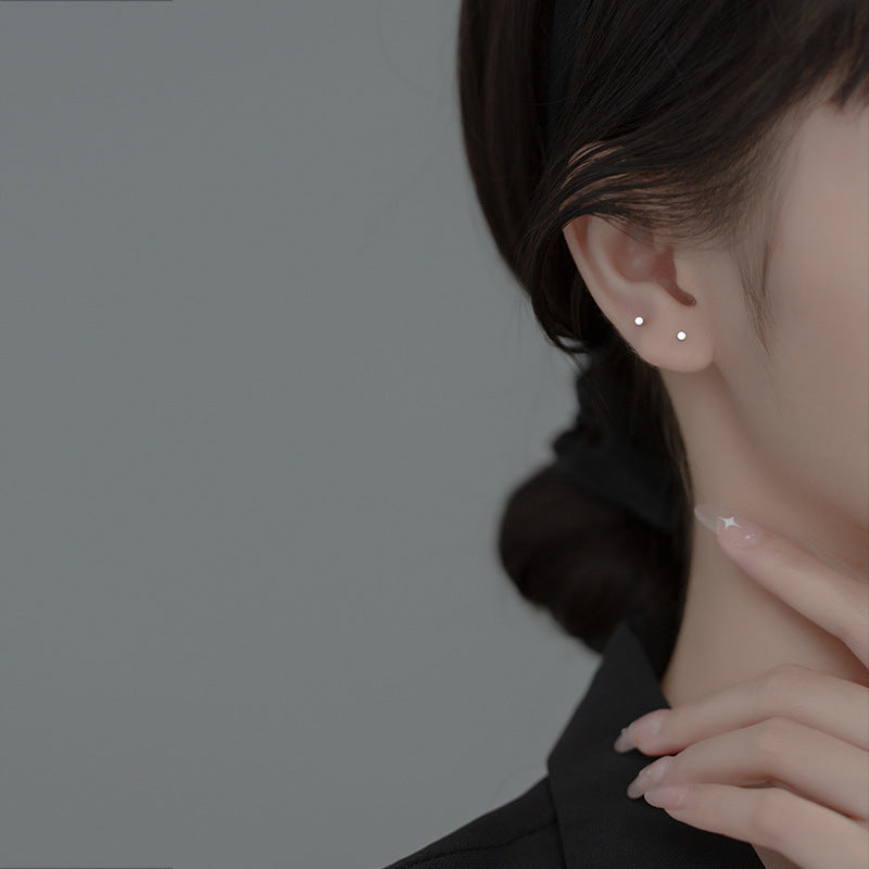Model showcasing the versatile and subtle style of the tiny circle stud earrings