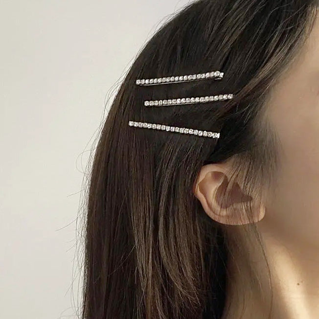 A model showcasing the elegant rhinestone hair clips in her hair.