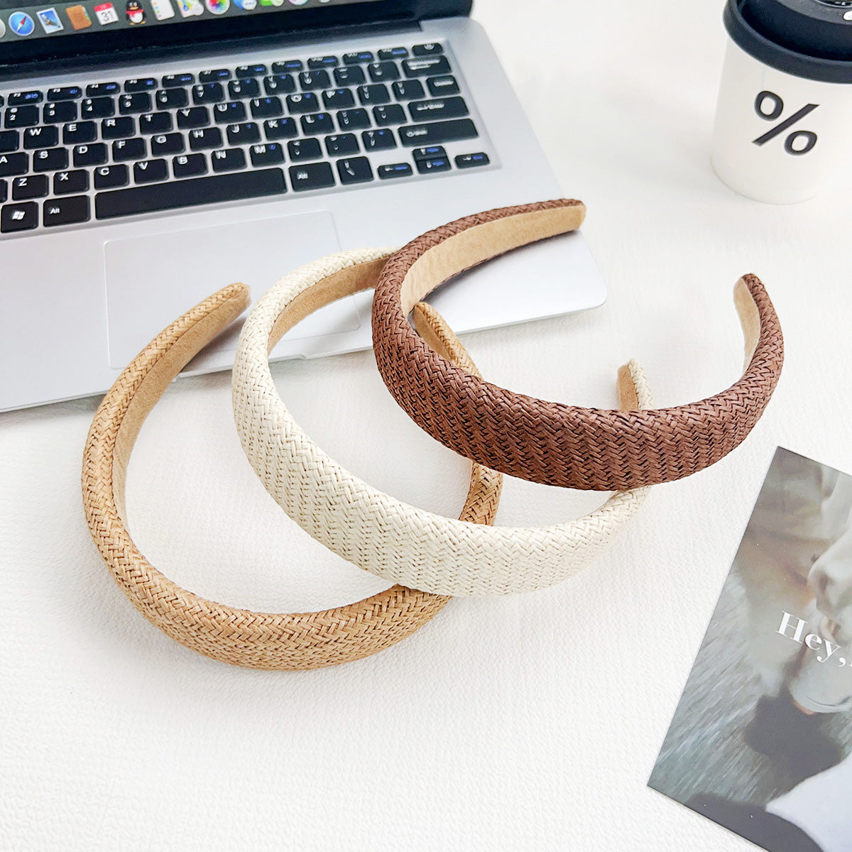 A collection of wide straw woven headbands in brown, beige, and white, perfect for wholesale.