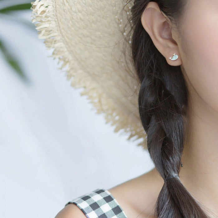 A model wearing the sterling silver blue whale earrings, showcasing their charming and stylish appeal.