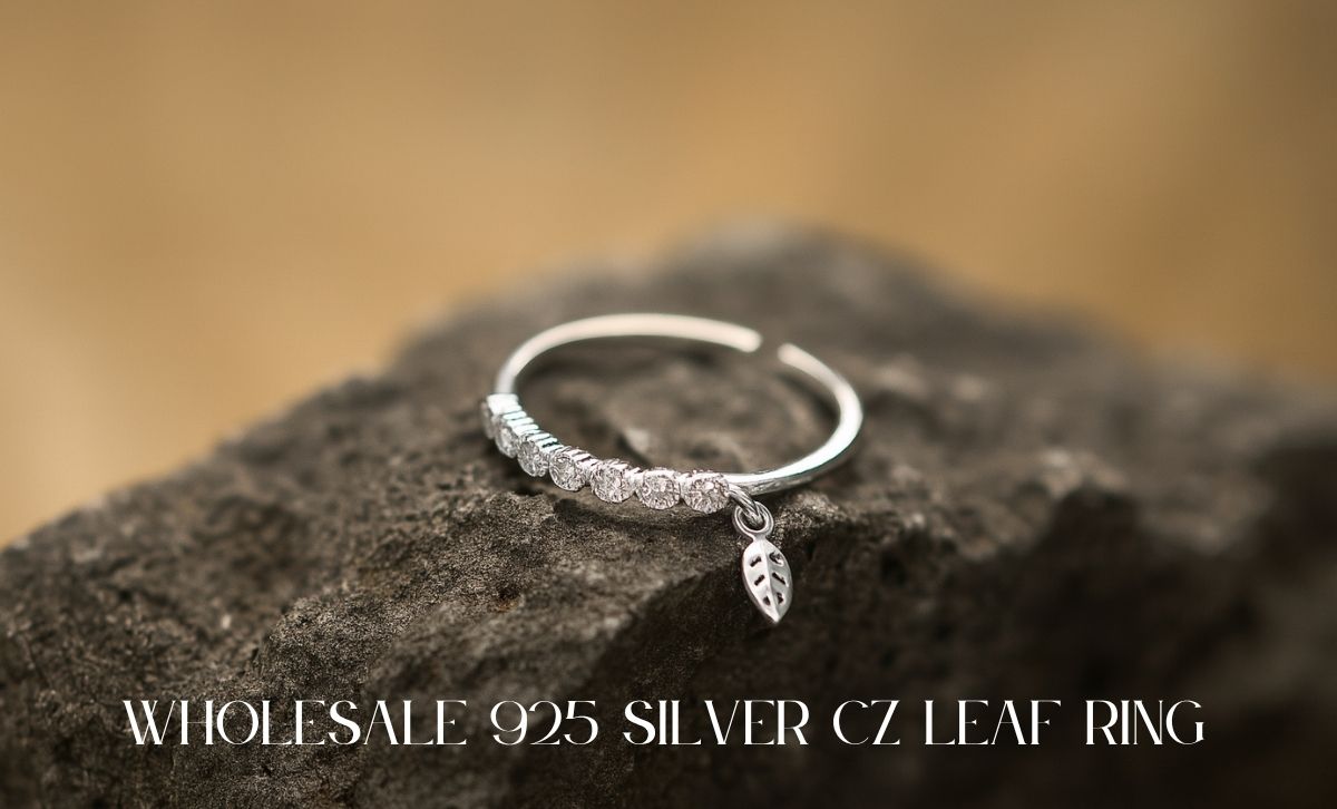Dainty 925 silver CZ leaf ring for women on rock surface – wholesale jewelry from factory