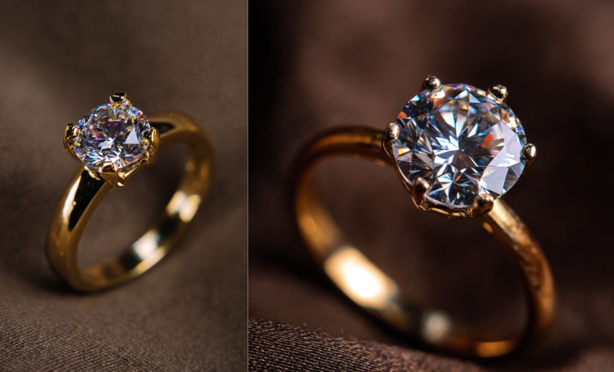 Close-up of brass engagement ring with cubic zirconia brilliant round cut on fabric background