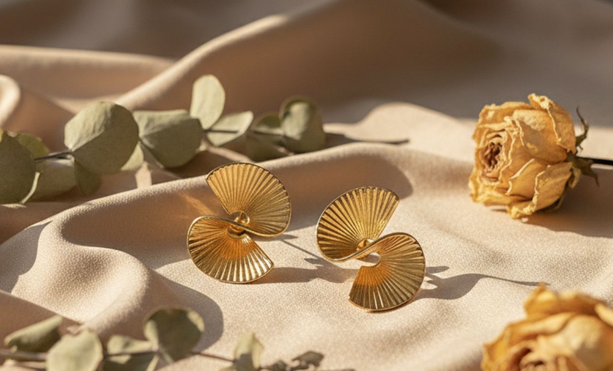 Geometric statement earrings with irregular hoop silhouette, chunky gold earrings styled for fashion boutiques and designer inspired collections.